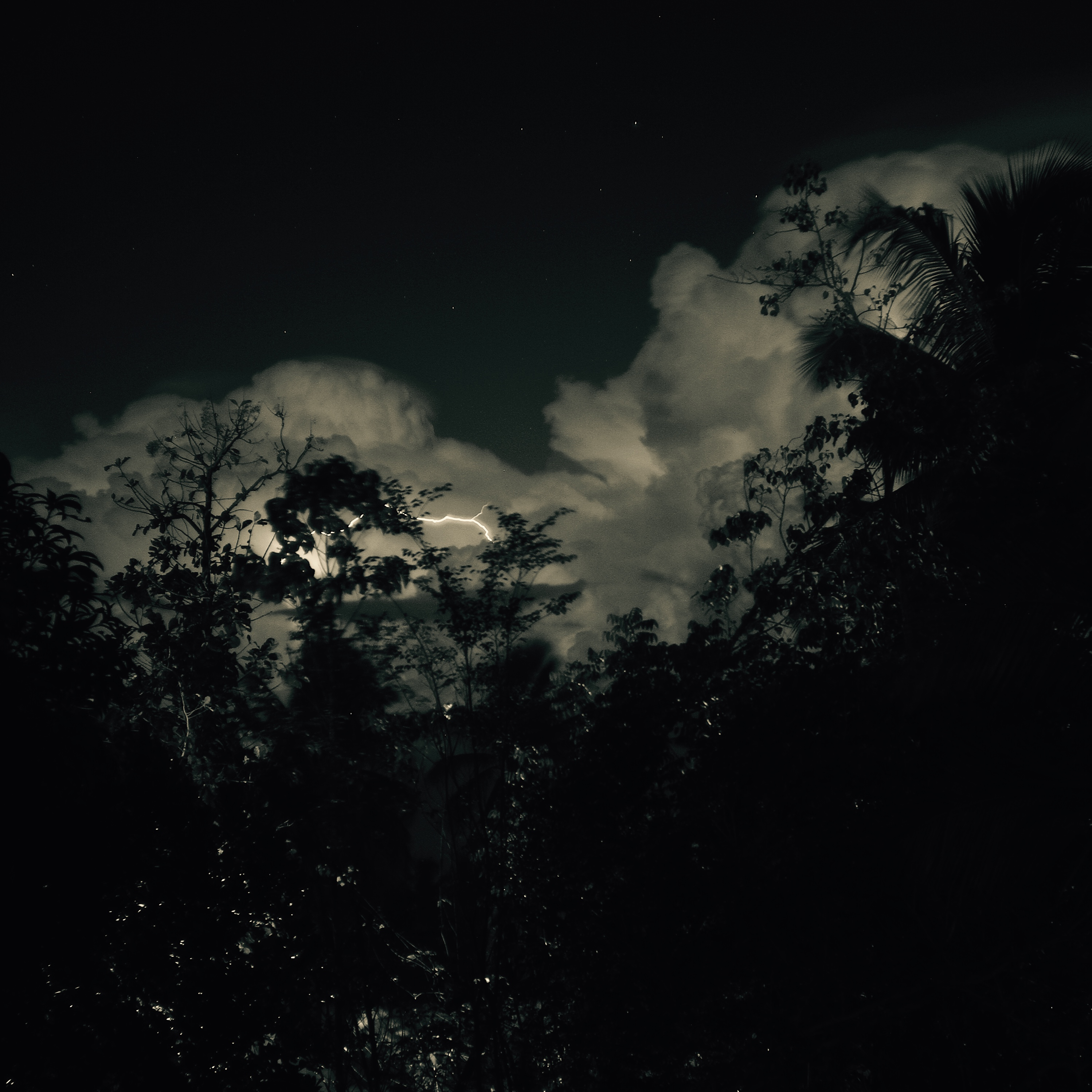 Cloud formation & lightning on a clear night sky